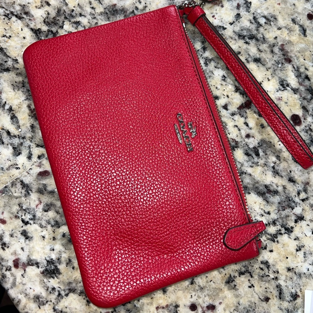 NWOT Small coach wristlet. Never used. Impeccable conditions.